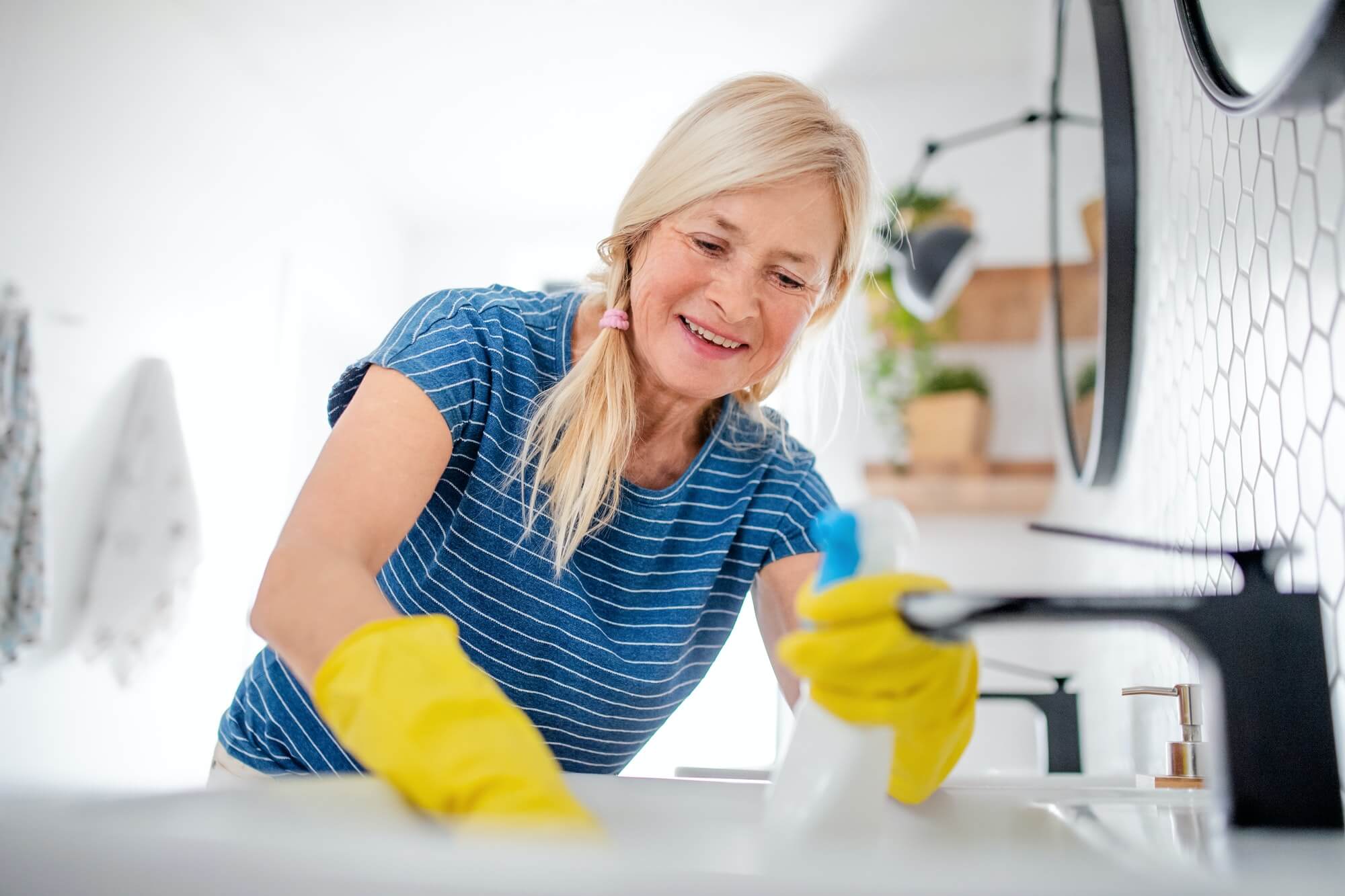 senior-woman-with-gloves-cleaning-bathroom-indoors-at-home.jpg